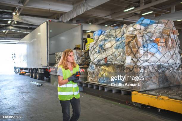 female airport warehouse crane operator - airport cargo stock pictures, royalty-free photos & images