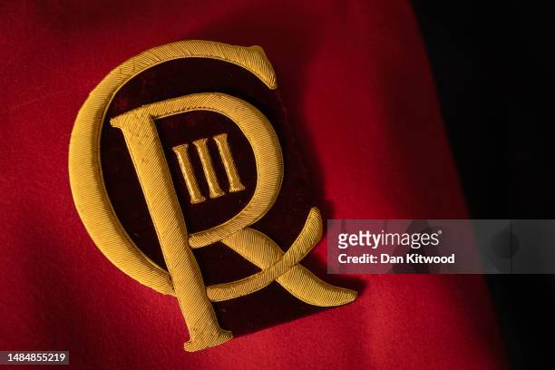 New CR III cyphers are cut out and prepared to be sewn onto ceremonial dress ahead of the Kings coronation, at Kashket & Partners on April 19, 2023...
