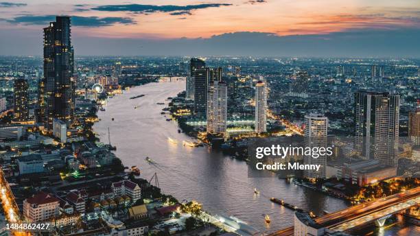 illuminated bangkok cityscape chao phraya river thailand sunset panorama - bangkok night stock pictures, royalty-free photos & images