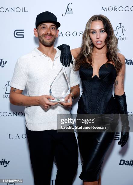 Bradley Kenneth, Music Stylist of the Year Award recipient, and Miley Cyrus, dressed in Versace, attend The Daily Front Row's Seventh Annual Fashion...