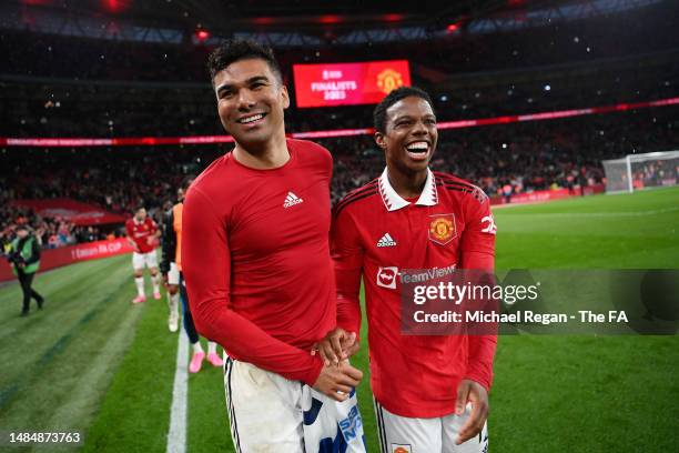 Casemiro and Tyrell Malacia of Manchester United celebrate after the team's victory in the Emirates FA Cup Semi Final match between Brighton & Hove...