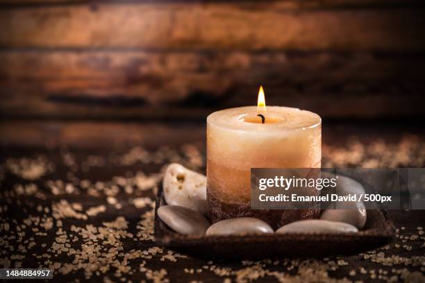 close-up of illuminated candle on table,romania - scented candle stock pictures, royalty-free photos & images