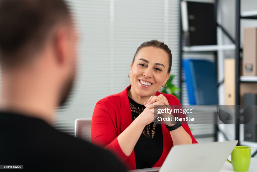 Businesswoman discussing with a businessman in office