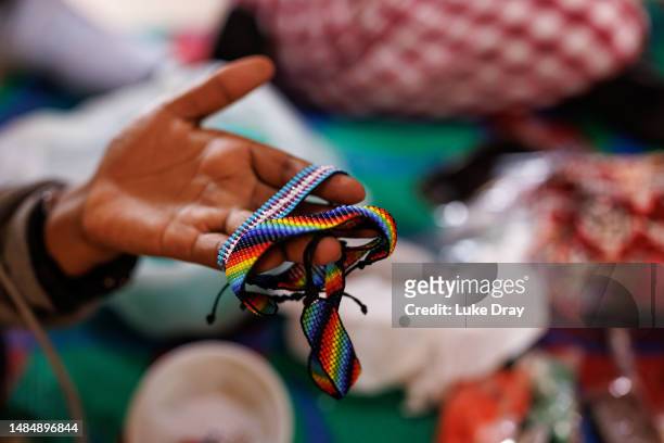 Woman identifying as a lesbian makes jewellery to sell whilst at a shelter for lesbian, bisexual, and queer women on April 24, 2023 in Kampala,...