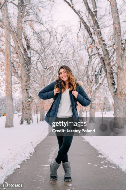 cute full length portrait of a happy university student standing looking at camera on campus on a snowy day in colorado - colorado state university stock pictures, royalty-free photos & images