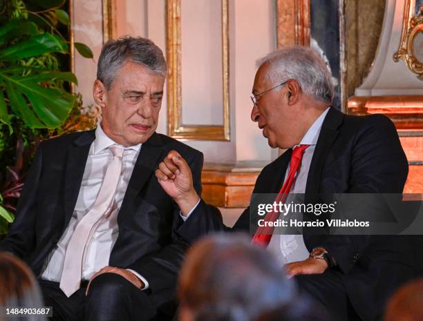 Brazilian singer and composer Chico Buarque chats onstage with Portuguese Prime Minister Antonio Costa during the ceremony of the Camões Prize to...