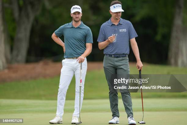 Wyndham Clark and Beau Hossler of the United States wait their turns on the 8th green during the Final Round of the Zurich Classic of New Orleans at...