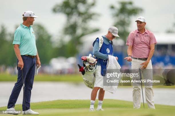 Brendon Todd and Patton Kizzire of the United States chat on the 18th green during the Final Round of the Zurich Classic of New Orleans at TPC...