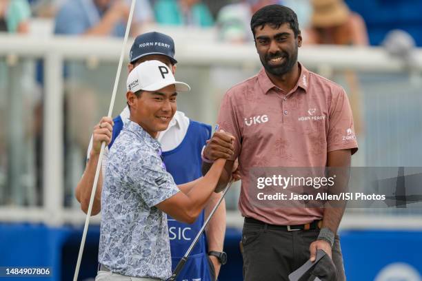 Justin Suh and Sahith Theegala of United States congratulate each other after completing the round on the 18th green during the Final Round of the...