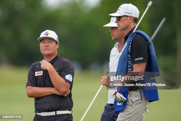 Sungjae Im of Korea and Keith Mitchell of the United States wait as other players take their turns on the 8th green during the Final Round of the...