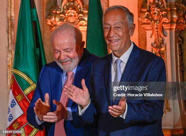 The President of Brazil Luiz Inácio Lula da Silva and Portuguese President Marcelo Rebelo de Sousa applaud after signing the award protocol during...
