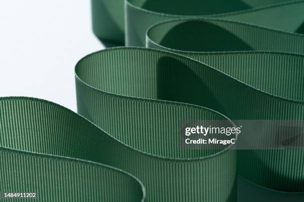 green ribbon twisted and distorted - s shape stock pictures, royalty-free photos & images