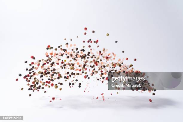 mixed peppercorns with pink salt floating in mid air - himalayan salt stock pictures, royalty-free photos & images