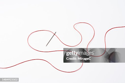 Red Curved Thread Passing Through A Sewing Needle High-Res Stock Photo ...