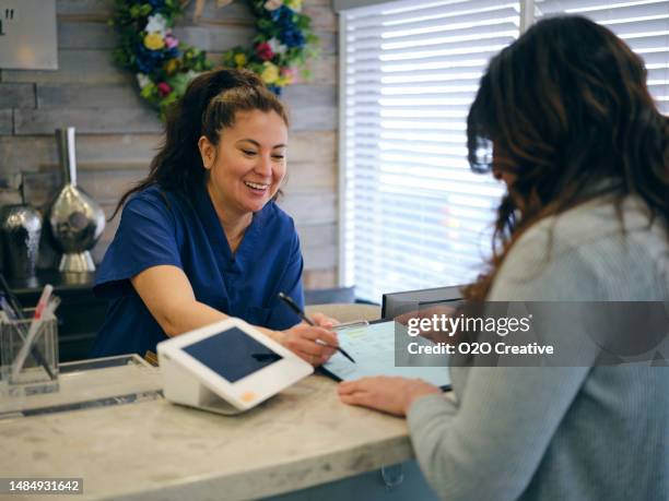 front desk at a medical office - medical reception desk stock pictures, royalty-free photos & images