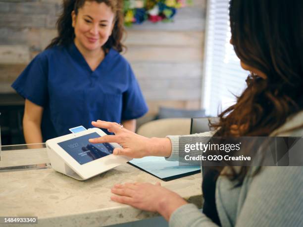 front desk at a medical office - medical reception desk stock pictures, royalty-free photos & images