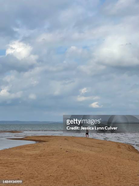 lone teenage boy walking lake shore. - one teenage boy only stock pictures, royalty-free photos & images