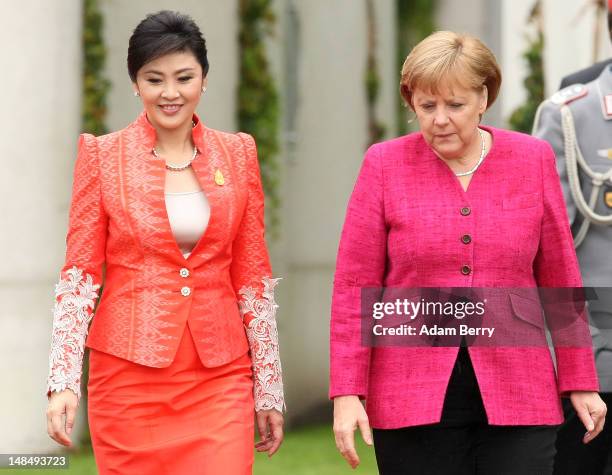 Thai Prime Minister Yingluck Shinawatra and German Chancellor Angela Merkel attend a military ceremony upon Yingluck's arrival at the German federal...