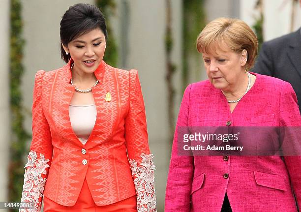 Thai Prime Minister Yingluck Shinawatra and German Chancellor Angela Merkel attend a military ceremony upon Yingluck's arrival at the German federal...