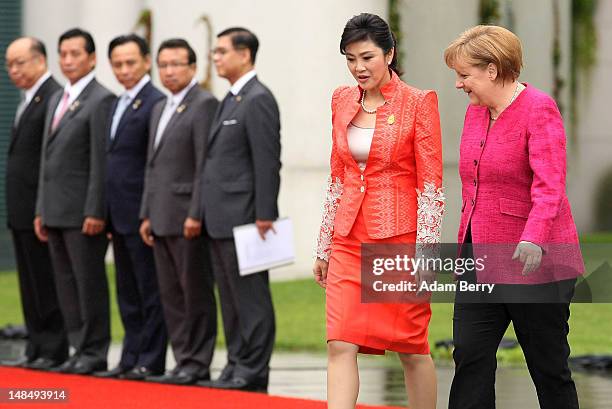 Thai Prime Minister Yingluck Shinawatra and German Chancellor Angela Merkel attend a military ceremony upon Yingluck's arrival at the German federal...