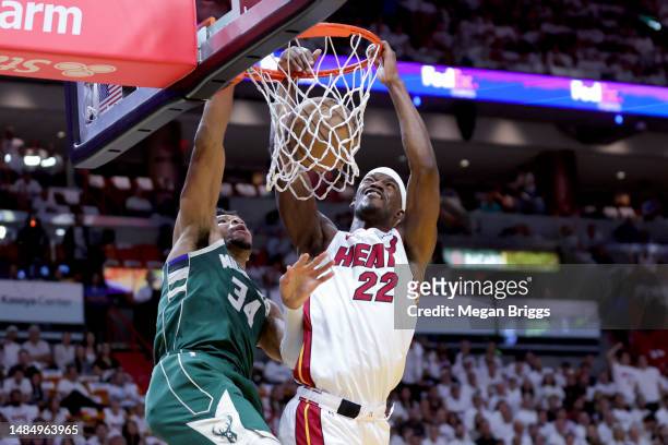 Jimmy Butler of the Miami Heat dunks over Giannis Antetokounmpo of the Milwaukee Bucks during the first quarter in Game Four of the Eastern...