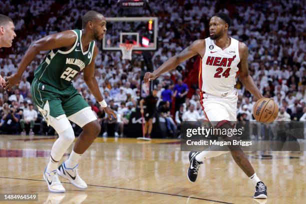 Haywood Highsmith of the Miami Heat dribbles the ball against Khris Middleton of the Milwaukee Bucks during the first quarter in Game Four of the...