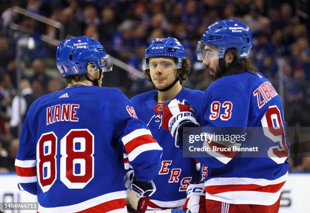 Patrick Kane, Artemi Panarin and Mika Zibanejad of the New York Rangers confer prior to a second period faceoff against the New Jersey Devils in Game...