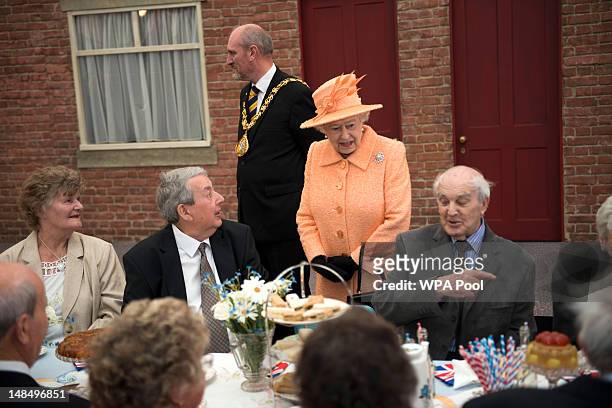 Queen Elizabeth II chats to people attending a street party during her visit on July 18, 2012 in Sunderland, England. During a two-day visit to the...