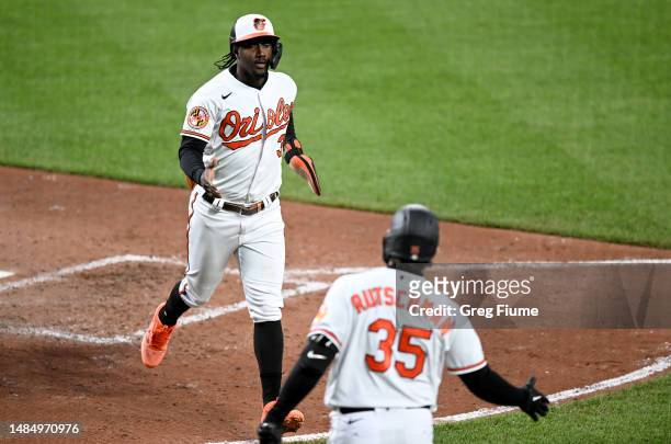 Jorge Mateo of the Baltimore Orioles celebrates with Adley Rutschman after scoring in the fifth inning against the Boston Red Sox at Oriole Park at...