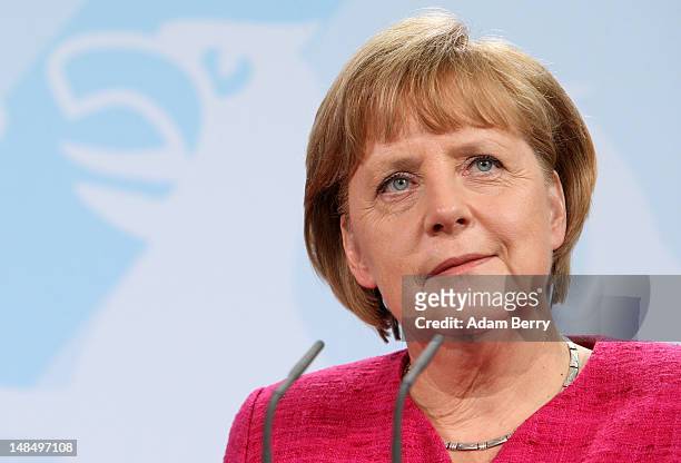 German Chancellor Angela Merkel listens during a news conference with Thai Prime Minister Yingluck Shinawatra at the German federal chancellory on...