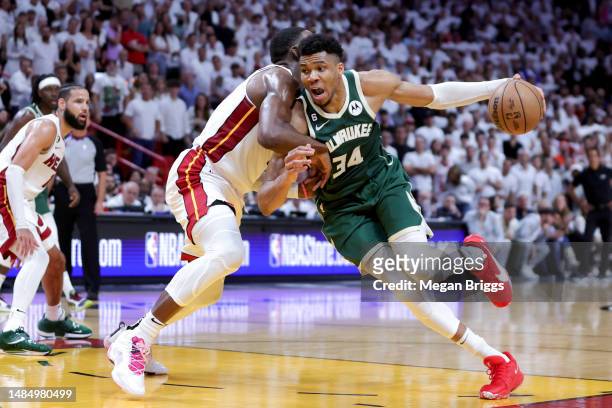 Giannis Antetokounmpo of the Milwaukee Bucks drives against Bam Adebayo of the Miami Heat during the fourth quarter in Game Four of the Eastern...