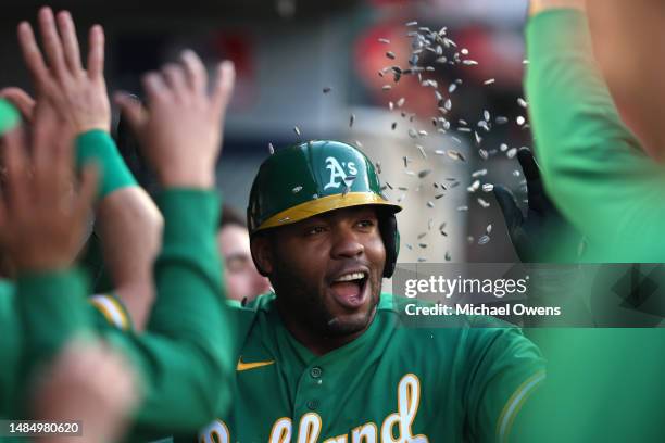 Jesus Aguilar of the Oakland Athletics celebrates with teammates after hitting a solo home run during the third inning against the Los Angeles Angels...