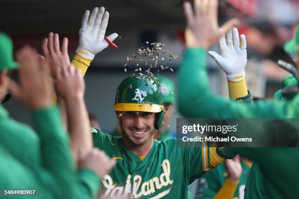 Brent Rooker of the Oakland Athletics celebrates with teammates after hitting a solo home run during the third inning against the Los Angeles Angels...