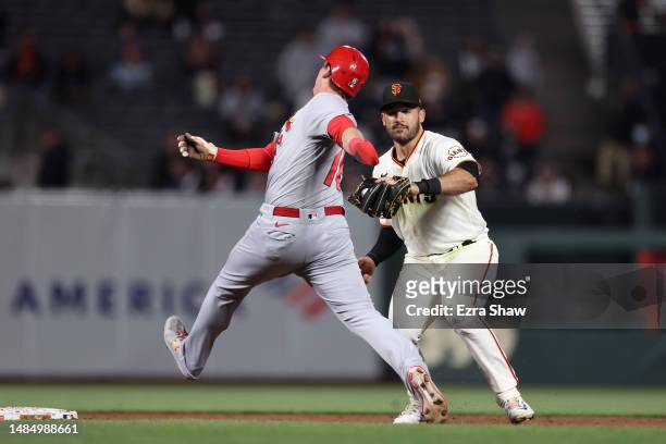 David Villar of the San Francisco Giants tags out Nolan Gorman of the St. Louis Cardinals on his way to turning a double play that ended the sixth...