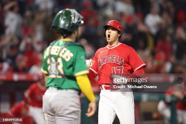 Shohei Ohtani of the Los Angeles Angels celebrates after scoring off of a two rbi double by Anthony Rendon against the Oakland Athletics during the...