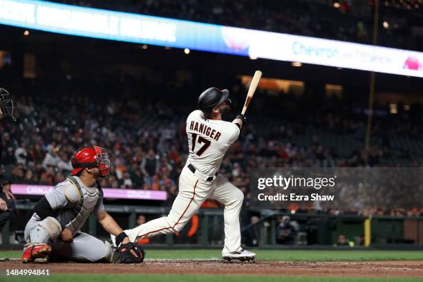 Mitch Haniger of the San Francisco Giants hits a sacrifice fly that scored a run against the St. Louis Cardinals in the seventh inning at Oracle Park...