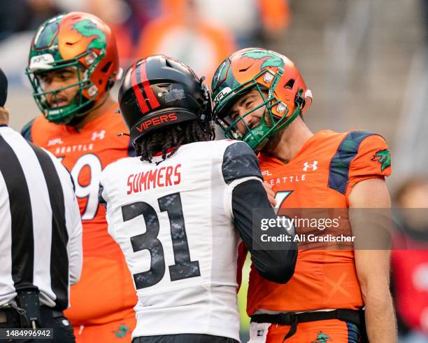 Quarterback Ben DiNucci of the Seattle Sea Dragons shakes hands with defensive back Jamar Summers of the Vegas Vipers during the second half of the...