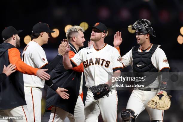 Alex Cobb of the San Francisco Giants is congratulated by teammates after he pitched a complete game shut out against the St. Louis Cardinals at...