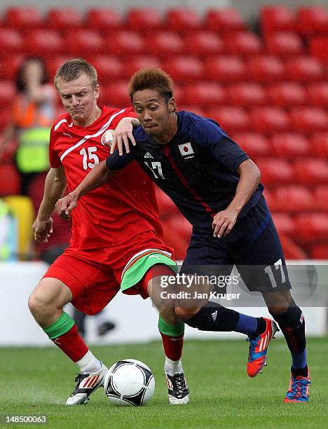 Hiroshi Kiyotake of Japan is fouled by Artem Solovei of Belarus during the International friendly match between Japan and Belarus at City Ground on...
