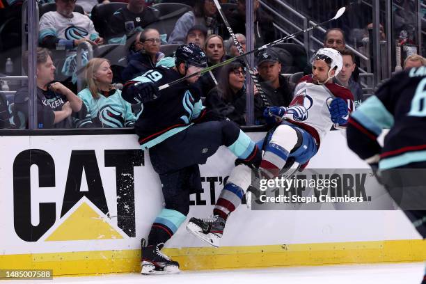 Vince Dunn of the Seattle Kraken checks Andrew Cogliano of the Colorado Avalanche during the third period in Game Four of the First Round of the 2023...