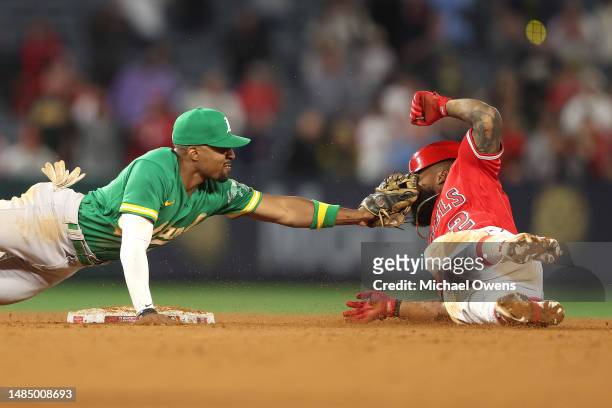 Tony Kemp of the Oakland Athletics tags out Luis Rengifo of the Los Angeles Angels at second base during the tenth inning at Angel Stadium of Anaheim...