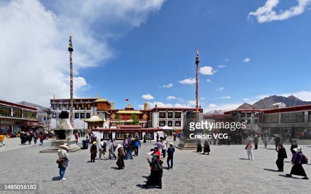 Tibetan Buddhism believers and tourists walk on Barkhor Street on April 24, 2023 in Lhasa, Tibet Autonomous Region of China.