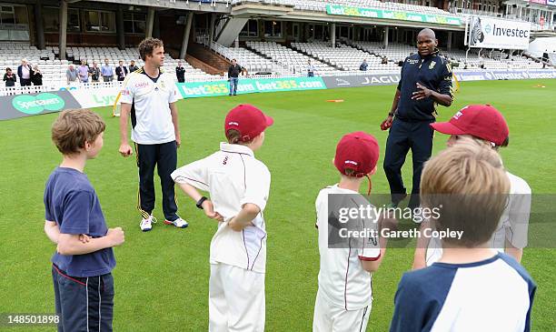 Albie Morkel and Lonwabo Tsotsobe of South Africa with local school children during a coaching clinic in aid of Nelson Mandela Day at The Kia Oval on...