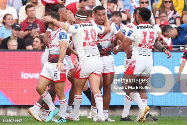 Tautau Moga of the Dragons celebrates with team mates after scoring a tryduring the round eight NRL match between Sydney Roosters and St George...