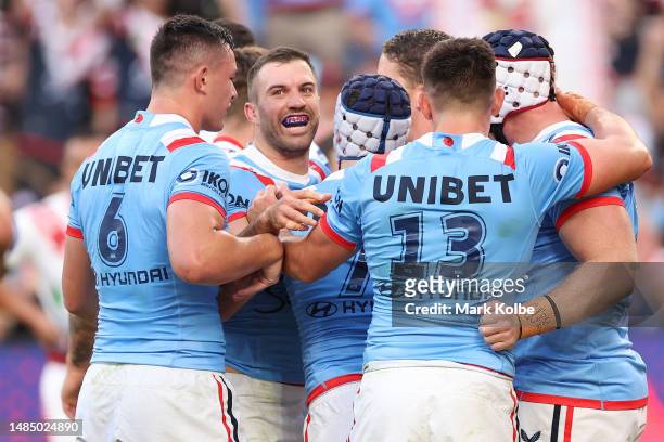 Luke Keary of the Roosters celebrates with team mates after scoring a try during the round eight NRL match between Sydney Roosters and St George...