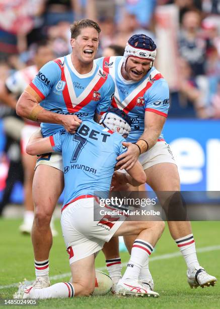 Luke Keary of the Roosters celebrates with team mates after scoring a try during the round eight NRL match between Sydney Roosters and St George...