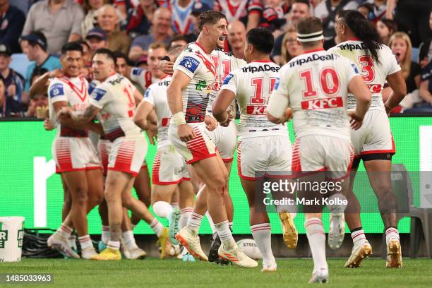 Zac Lomax of the Dragons celebrates with team mates after a try scored by Tyrell Sloan during the round eight NRL match between Sydney Roosters and...