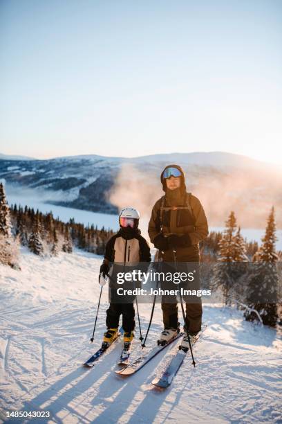 father and child skiing together - family skiing stock pictures, royalty-free photos & images