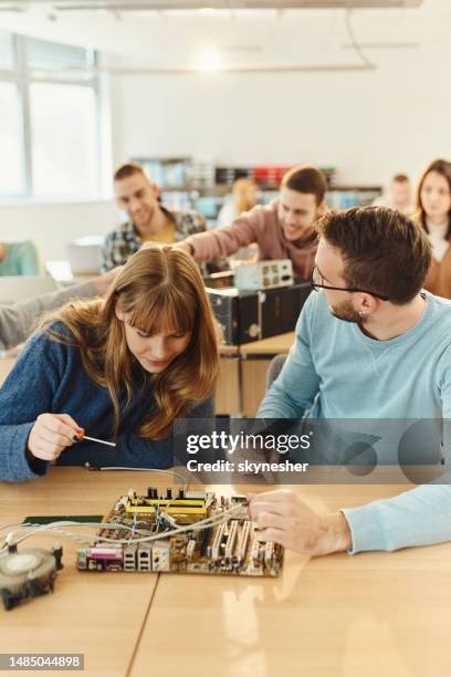 college students repairing computer chip on a class. - school science project stock pictures, royalty-free photos & images