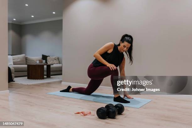 view of woman exercising at home - kneeling stock pictures, royalty-free photos & images